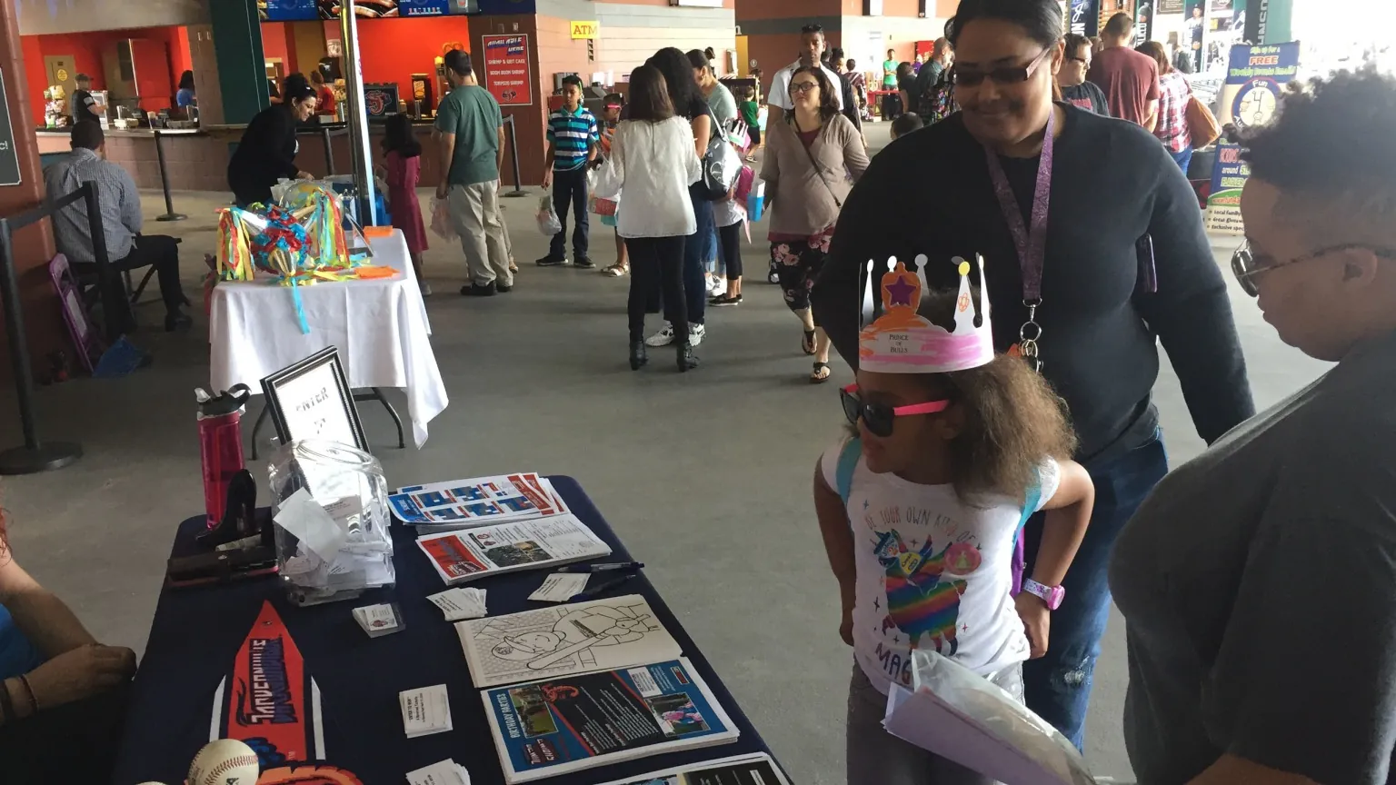 A family visiting a vendor display on the concourse