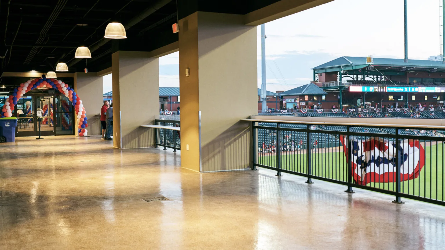 The open-air walkway and field view beside Harbour Hall